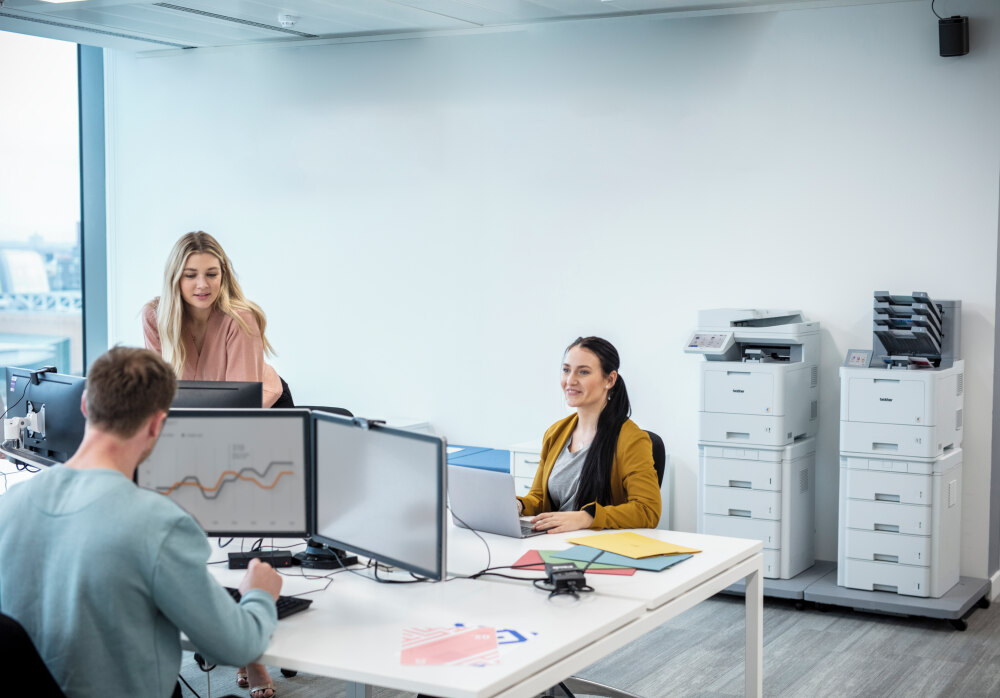 office workers with Brother printers in background